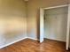 Neutral bedroom with wood floors and walk-in closet at 21636 King Henry Ave, Leesburg, FL 34748