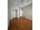 Spacious bedroom with wood-look floors, closet, and ceiling fan for comfort at 21636 King Henry Ave, Leesburg, FL 34748