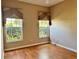 Cozy bedroom featuring wood floors and natural light at 21636 King Henry Ave, Leesburg, FL 34748