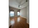 Cozy bedroom with two windows providing lots of natural light and wood-look flooring at 21636 King Henry Ave, Leesburg, FL 34748