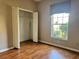 Bedroom featuring a closet, window, and wood floors at 21636 King Henry Ave, Leesburg, FL 34748