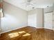 Bright bedroom showcasing hardwood floors, a ceiling fan, and a large closet with double doors at 21636 King Henry Ave, Leesburg, FL 34748
