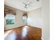 Bright and airy bedroom with hardwood floors, large windows, and neutral-toned walls at 21636 King Henry Ave, Leesburg, FL 34748
