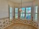 Breakfast nook offers bright light from the large windows and tile floors at 21636 King Henry Ave, Leesburg, FL 34748