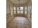 Bright dining area featuring a large bay window with shutters and tile flooring at 21636 King Henry Ave, Leesburg, FL 34748