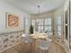 Bright dining room with a round table and four chairs near shuttered windows at 21636 King Henry Ave, Leesburg, FL 34748
