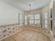 A dining room with floral wallpaper, shuttered windows, and tiled floors at 21636 King Henry Ave, Leesburg, FL 34748