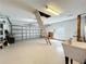 Expansive garage space with a utility sink, garage door, and access ladder to storage at 21636 King Henry Ave, Leesburg, FL 34748
