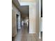 Interior hallway features tile flooring, neutral paint, and access to various rooms at 21636 King Henry Ave, Leesburg, FL 34748