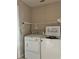 Laundry room with a washer and dryer and overhead shelving at 21636 King Henry Ave, Leesburg, FL 34748