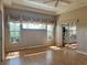 Living room with windows, ceiling fan, and sliding glass door at 21636 King Henry Ave, Leesburg, FL 34748