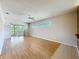 Living room with laminate floors, sliding glass doors, and lots of natural light at 21636 King Henry Ave, Leesburg, FL 34748