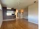 Open living space with wood floors and tile transition at 21636 King Henry Ave, Leesburg, FL 34748