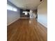 Spacious living room with wood-look floors that transitions to the kitchen area at 21636 King Henry Ave, Leesburg, FL 34748