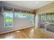 Bright bedroom with large windows offering views of the lush green backyard at 21636 King Henry Ave, Leesburg, FL 34748