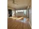 Main bedroom with natural light and wood-look floors with ensuite bathroom access at 21636 King Henry Ave, Leesburg, FL 34748