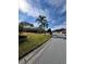 Street view of the house with beautiful landscaping and a well-kept lawn at 21636 King Henry Ave, Leesburg, FL 34748