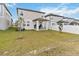 View of the backyard with a covered patio area, a white fence, and well-maintained grass at 2242 Huntsman Ridge Rd, Clermont, FL 34715