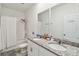 Bright bathroom with double sinks, granite countertop, and a shower-tub combo at 2242 Huntsman Ridge Rd, Clermont, FL 34715