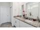 Bathroom featuring double vanity with granite countertop and a large mirror above at 2242 Huntsman Ridge Rd, Clermont, FL 34715