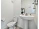 Clean half bath with pedestal sink, toilet, and mirror at 2242 Huntsman Ridge Rd, Clermont, FL 34715