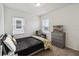 Well-lit bedroom features neutral walls, carpet, and a bed with a modern black and yellow comforter at 2242 Huntsman Ridge Rd, Clermont, FL 34715