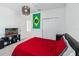 Bedroom featuring a spherical light fixture, closet doors, and a red comforter on a black frame at 2242 Huntsman Ridge Rd, Clermont, FL 34715