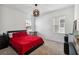 Bedroom featuring modern light fixture, carpet flooring, natural light, and a sleek black bedframe at 2242 Huntsman Ridge Rd, Clermont, FL 34715