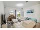 Bright living room with a white leather couch, television, and sliding glass doors at 2242 Huntsman Ridge Rd, Clermont, FL 34715