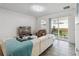 Cozy living room with a white leather couch and a sliding glass door to the patio at 2242 Huntsman Ridge Rd, Clermont, FL 34715