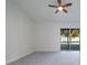 A bright bedroom features a ceiling fan and a sliding glass door to the outdoor pool area at 2555 Sweetwater Trl, Maitland, FL 32751