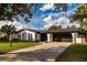 Charming single-story home with a two-car garage, manicured lawn, and beautiful landscaping at 2555 Sweetwater Trl, Maitland, FL 32751