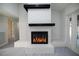 Close-up of fireplace with white brick, dark wood mantle and view of outdoor pool at 2555 Sweetwater Trl, Maitland, FL 32751