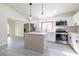 Modern kitchen featuring stainless steel appliances, white cabinetry, and a central island for food preparation at 2555 Sweetwater Trl, Maitland, FL 32751