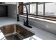 Close-up of kitchen sink with gooseneck faucet and window overlooking the backyard at 2555 Sweetwater Trl, Maitland, FL 32751