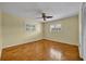 Bedroom with wood parquet floors, a ceiling fan, and two large windows at 2642 Tierra Cir, Winter Park, FL 32792