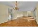 Open-concept living area features parquet floors, a chandelier and a clear view into the adjacent kitchen space at 2642 Tierra Cir, Winter Park, FL 32792