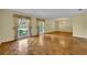 Spacious living room with parquet floors, decorative chandelier, and large windows that provide ample natural light at 2642 Tierra Cir, Winter Park, FL 32792