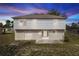 View of the home's rear facade and partially fenced-in backyard at 2645 Coachman Dr, Deltona, FL 32738