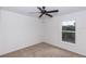 Neutral bedroom featuring a large window and carpet flooring at 2645 Coachman Dr, Deltona, FL 32738