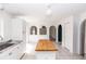 Bright kitchen featuring a butcher block island, white cabinetry, and seamless arched entries at 2645 Coachman Dr, Deltona, FL 32738