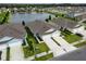 An aerial view shows the well-maintained exteriors of neighboring homes overlooking a scenic pond with a water fountain at 2821 Sunridge Loop, St Cloud, FL 34771