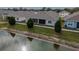 This backyard view looks out over the pond and features a covered, screened-in patio of the home at 2821 Sunridge Loop, St Cloud, FL 34771