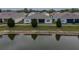 This backyard view looks out over the pond and features a covered, screened-in patio of the home at 2821 Sunridge Loop, St Cloud, FL 34771