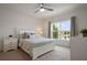 Serene bedroom with a pond view, a ceiling fan, and carpet flooring, filled with plenty of natural light at 2821 Sunridge Loop, St Cloud, FL 34771