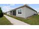 Home exterior featuring a screened patio and side yard at 2821 Sunridge Loop, St Cloud, FL 34771