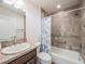 Bathroom featuring a shower, tub combo, neutral tile, vanity, and framed mirror at 2936 Suber St, The Villages, FL 32163