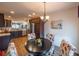 Bright dining area with a round table, views of the kitchen, and a decorative chandelier at 2936 Suber St, The Villages, FL 32163