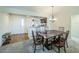 Cozy dining area with a decorative chandelier, comfortable seating, and a view into the kitchen at 2936 Suber St, The Villages, FL 32163