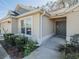 Inviting front entrance with well-maintained landscaping, neutral-colored stucco, and a covered porch at 2936 Suber St, The Villages, FL 32163